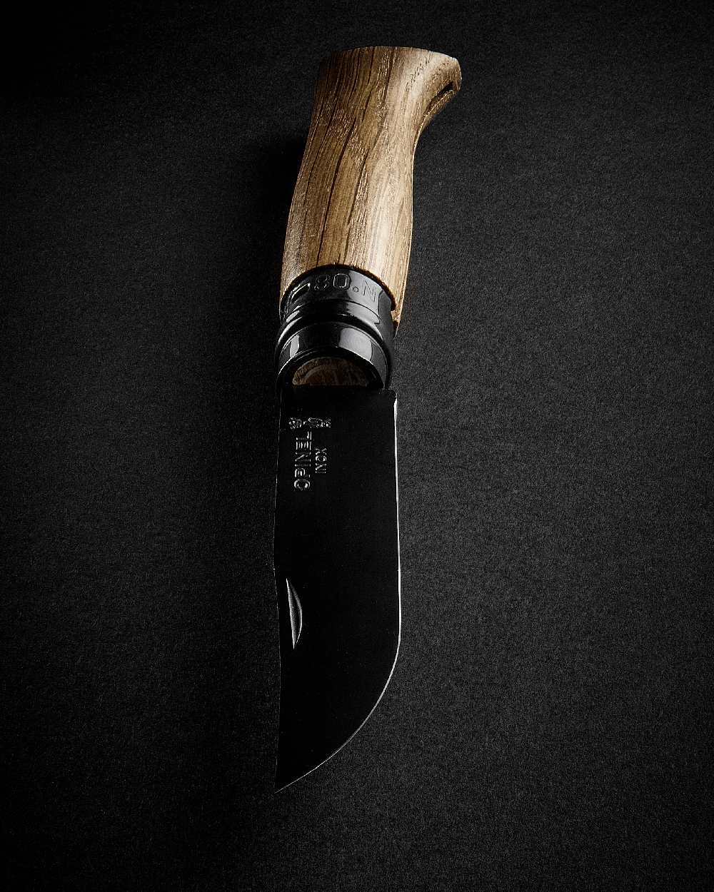 Black coloured Opinel No.8 Black Oak Knife on black background 