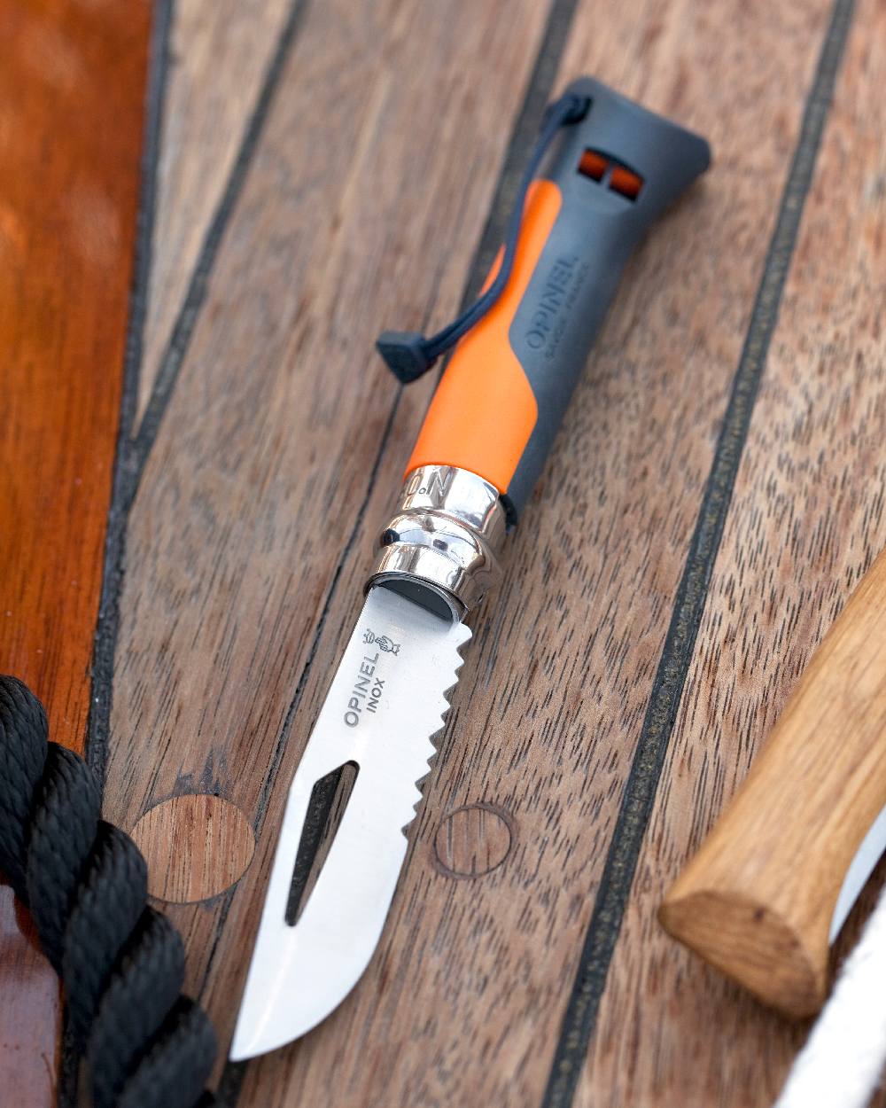 Orange coloured Opinel No.8 Outdoor Knife on wood background 