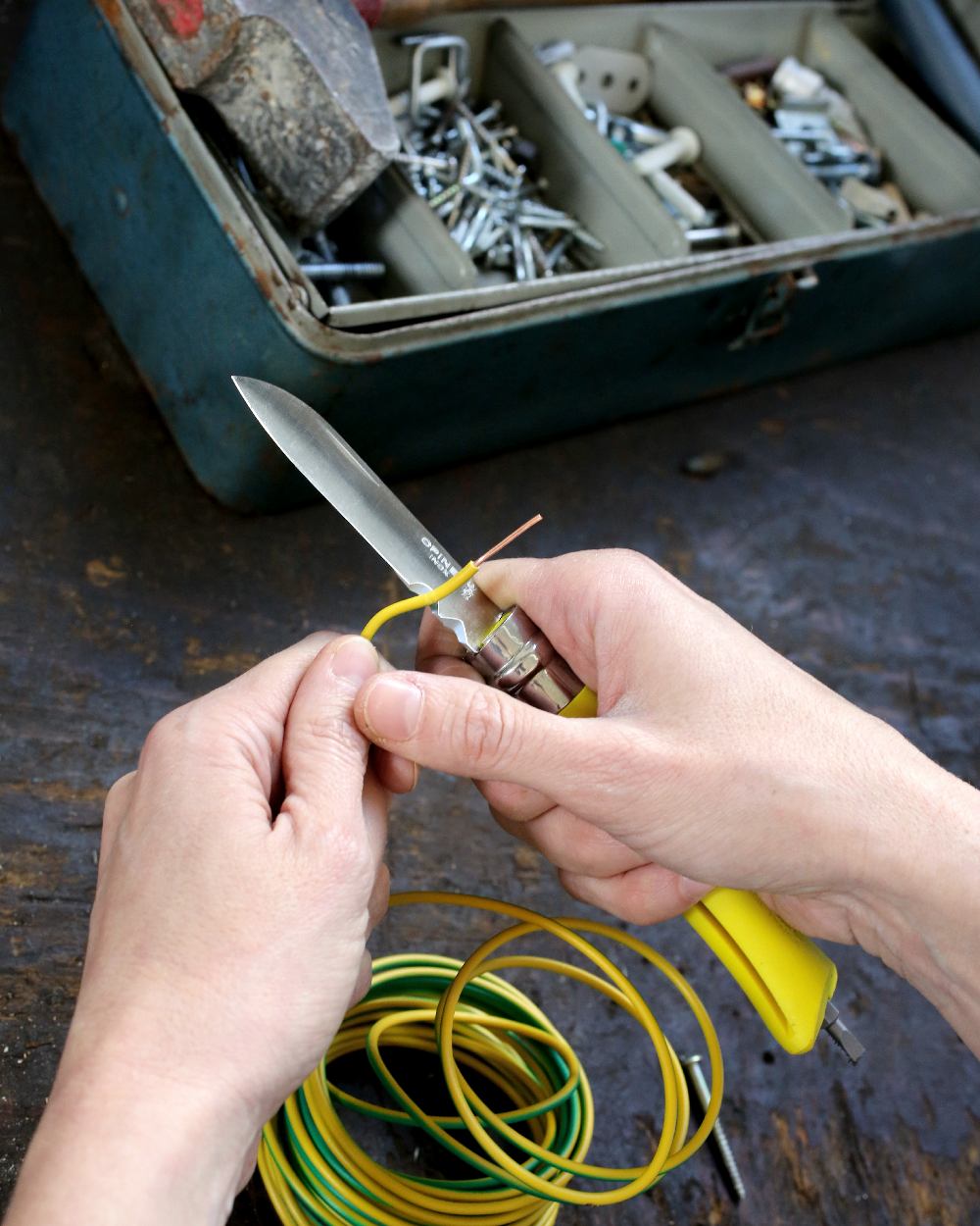 Yellow coloured Opinel No.9 DIY Knife on workstation background 