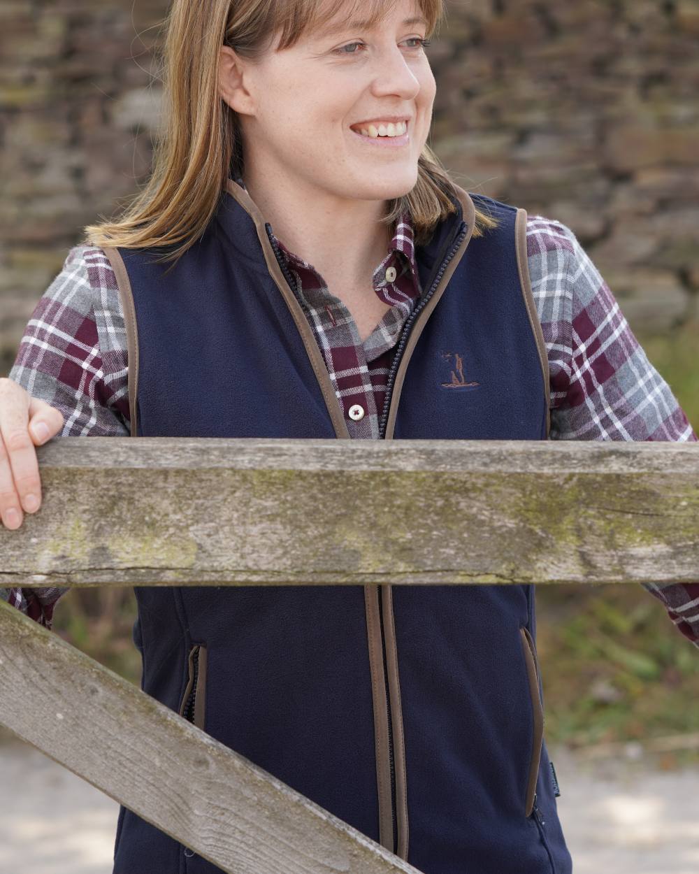 Navy coloured Percussion Ladies Scotland Fleece Gilet on farm background 