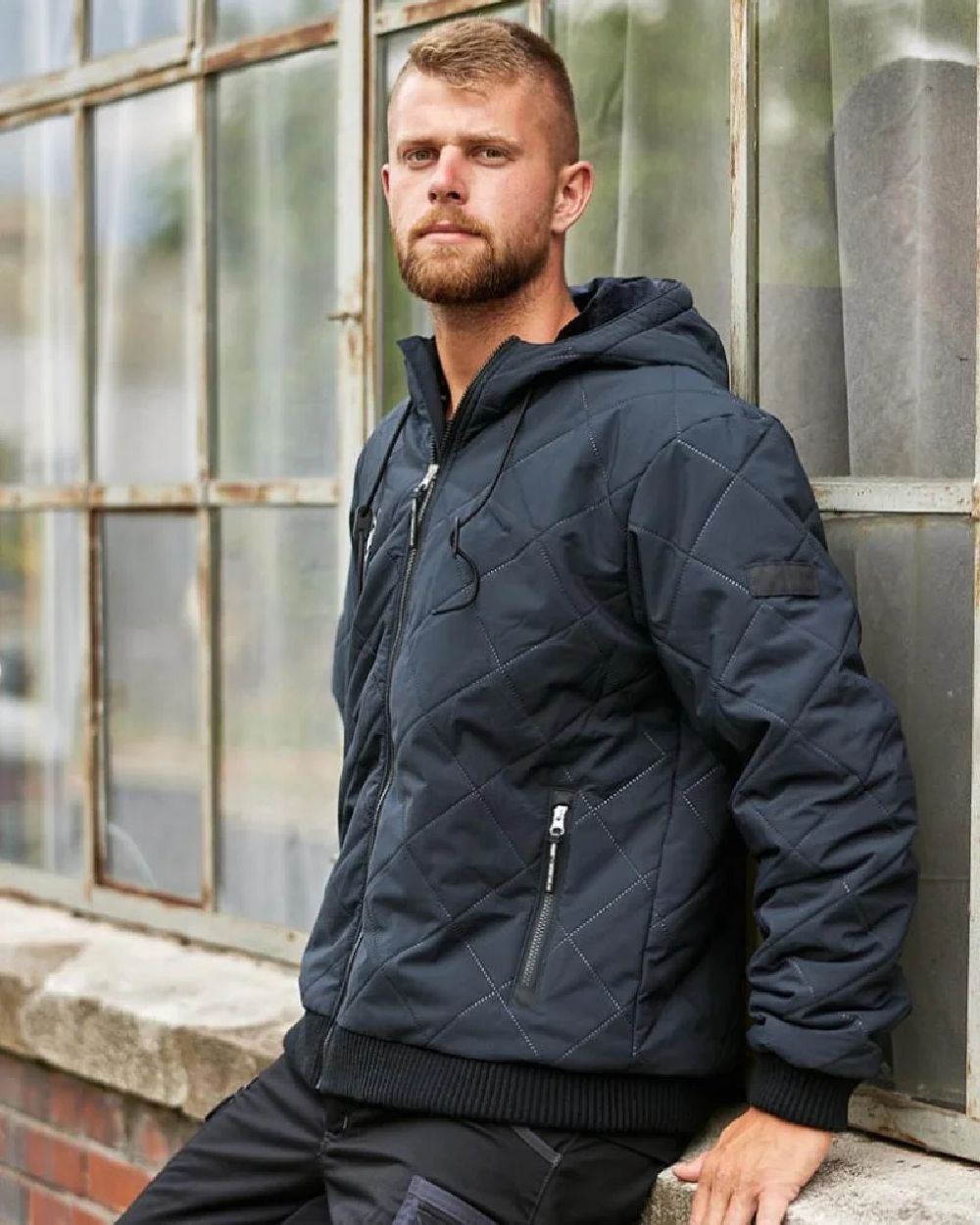 Carbon Coloured Puma Workwear Mens Essentials Hooded Winter Work Jacket on outdoor background 