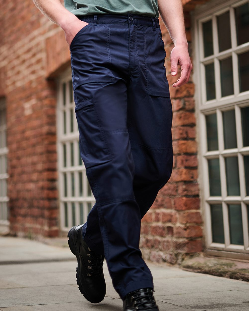 Navy coloured Regatta Action Trousers on brick wall background 