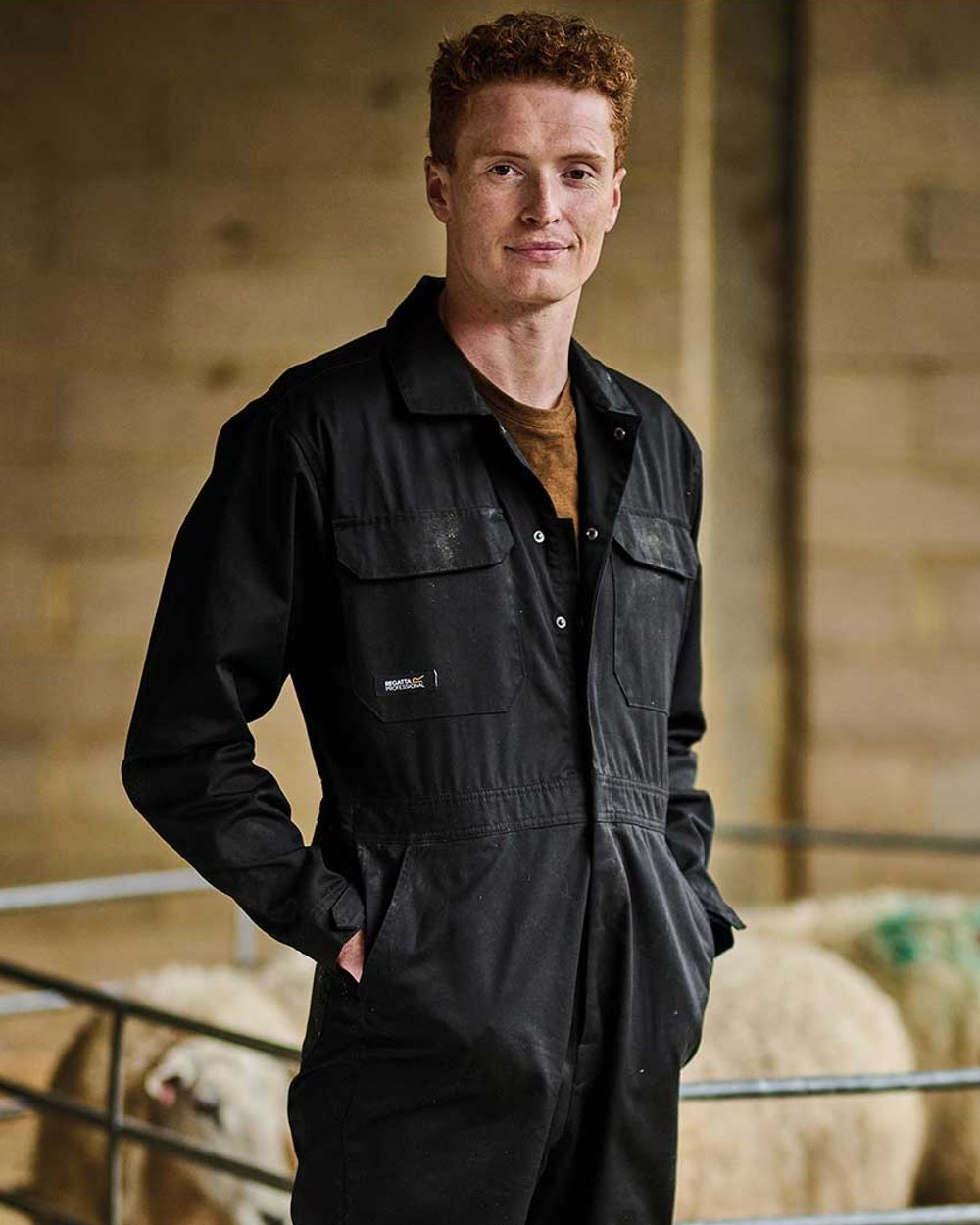 Black coloured Regatta Pro Stud Fasten Coverall on blurry background 