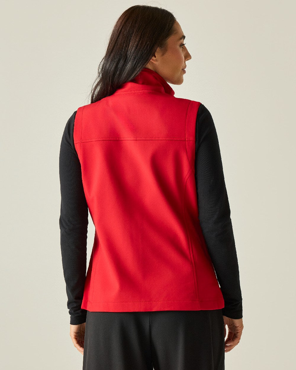 Classic Red coloured Regatta Professional Womens Flux Softshell Bodywarmer on beige background 