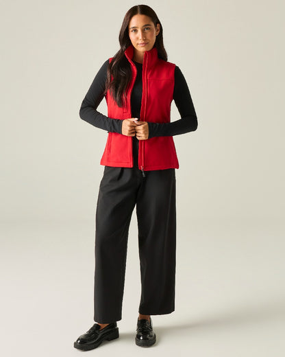 Classic Red coloured Regatta Professional Womens Flux Softshell Bodywarmer on beige background 