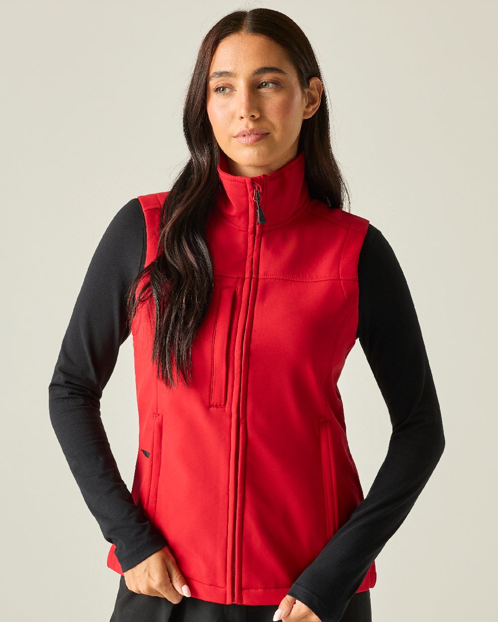 Classic Red coloured Regatta Professional Womens Flux Softshell Bodywarmer on beige background 