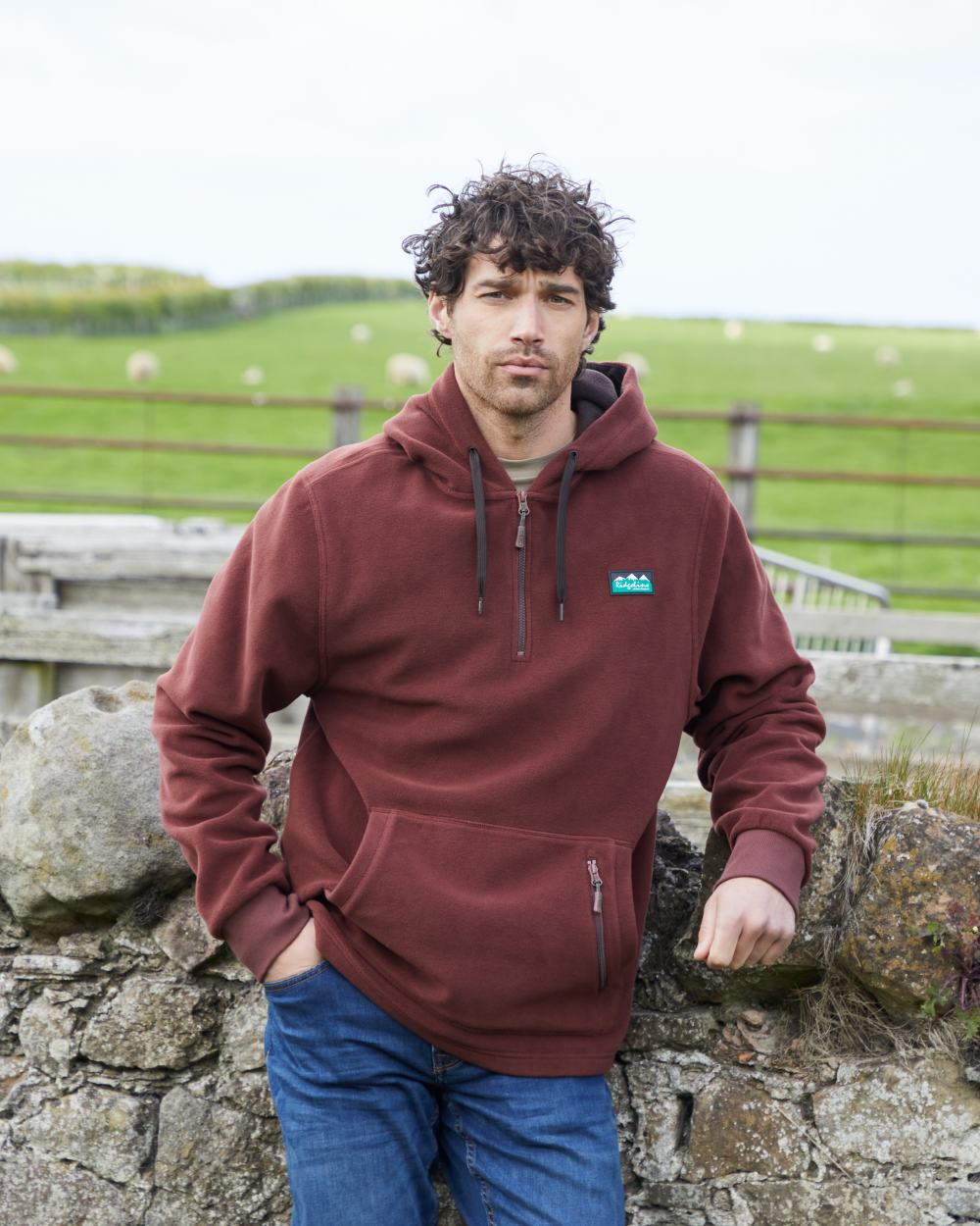 Oxblood coloured Ridgeline Ballistic Hooded Fleece on farm background 