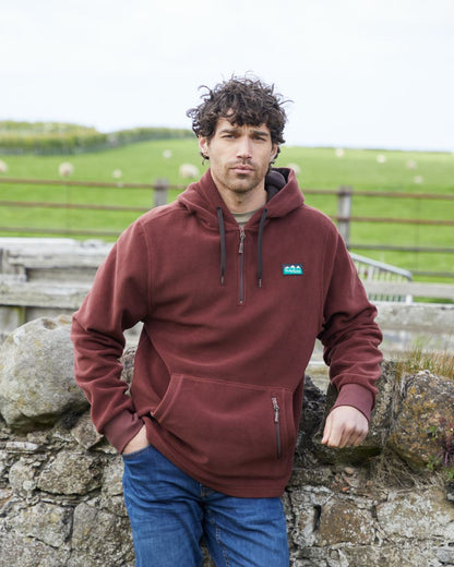 Oxblood coloured Ridgeline Ballistic Hooded Fleece on farm background 