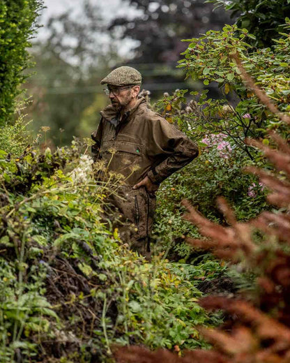 Heather Brown coloured Ridgeline Evolution Waterproof Smock on blurry plants background 