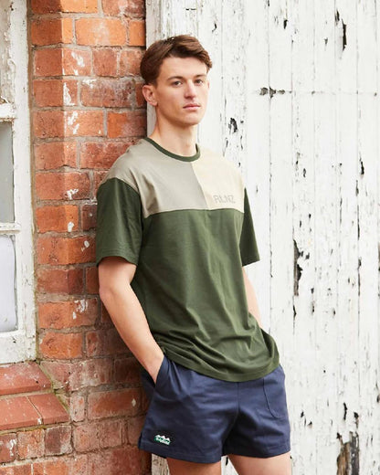 Navy coloured Ridgeline Hose Down Shorts on brick wall background 