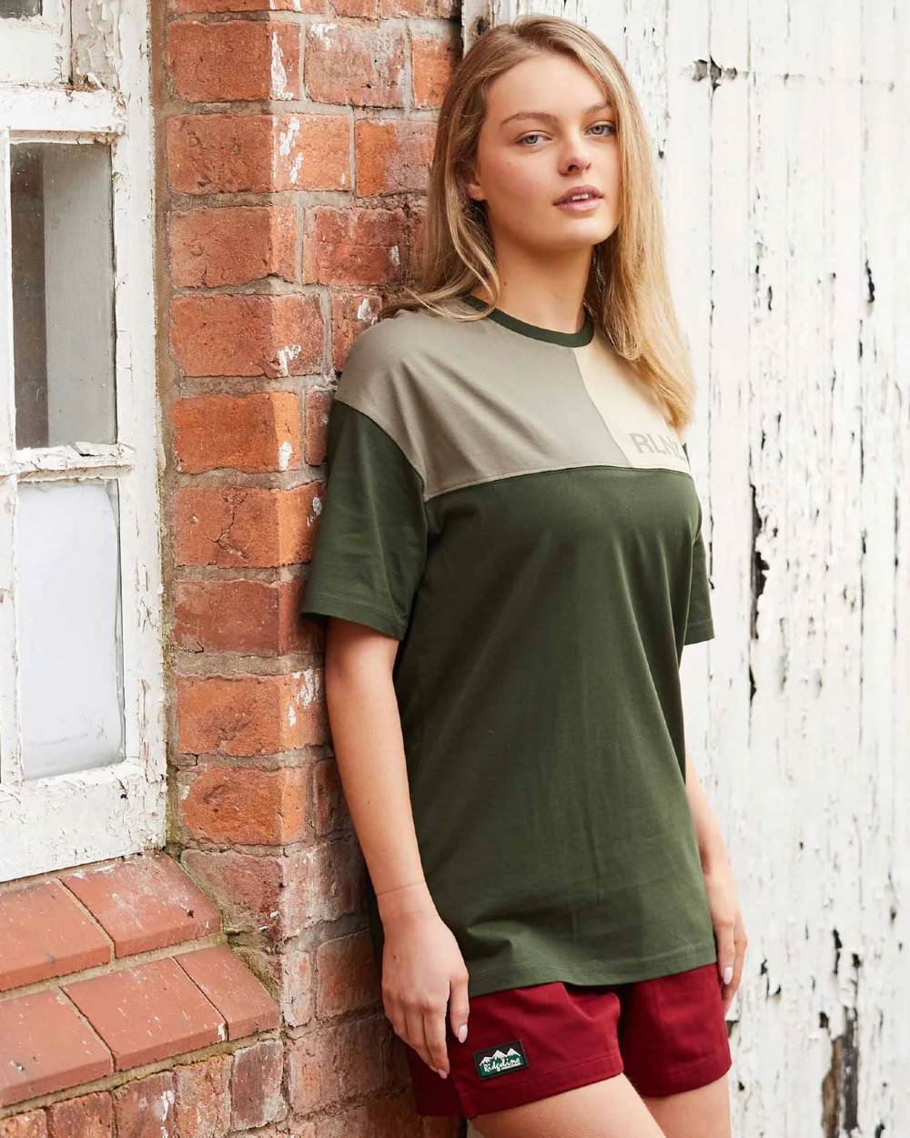 Rhubarb coloured Ridgeline Hose Down Shorts on brick wall background 