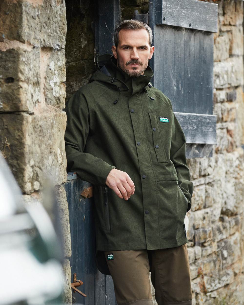 Deep Forest Marl coloured Ridgeline Mens Monsoon Light Jacket on wall background 