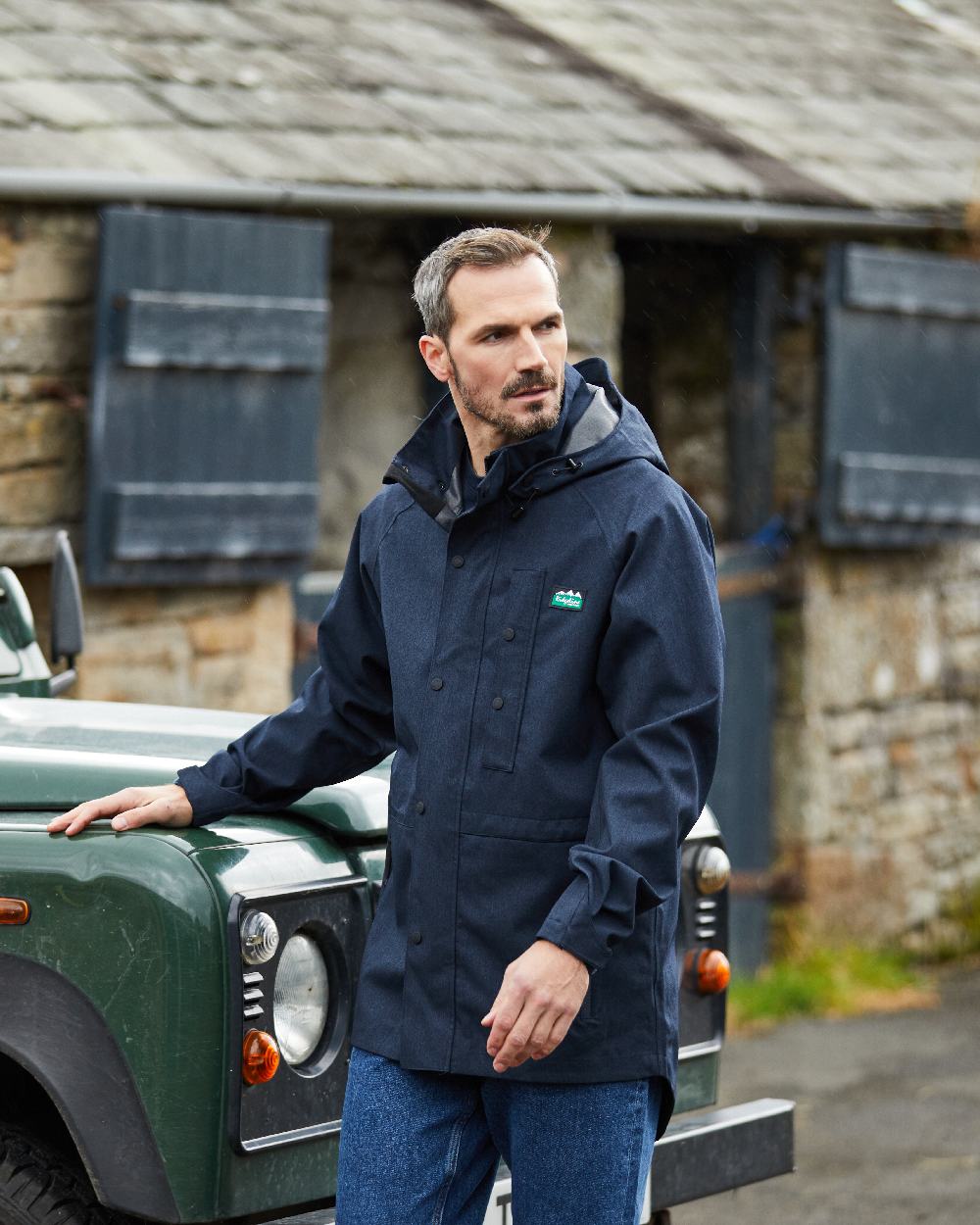 Navy Marl coloured Ridgeline Mens Monsoon Light Jacket on house background 