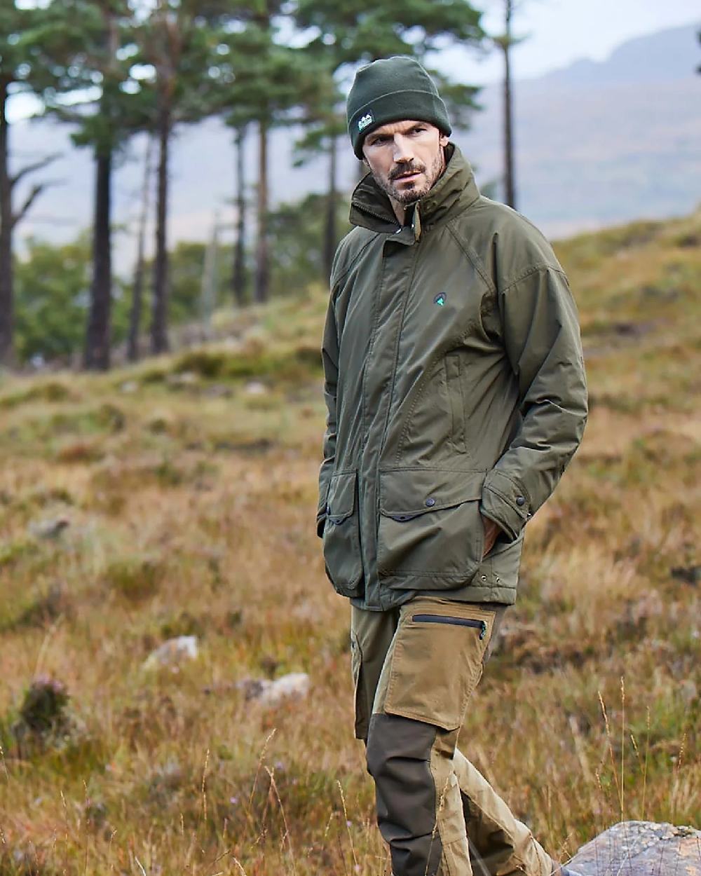 Olive Drab Ridgeline Sovereign Field Coat on blurry mountain background 