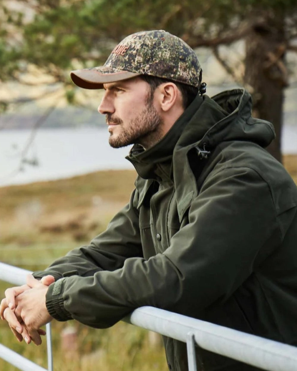 Olive coloured Ridgeline Torrent III Waterproof Jacket on blurry background 