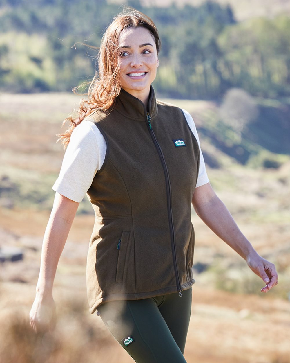 Moody Teak coloured Ridgeline Womens Kodiak Gilet on mountain background 