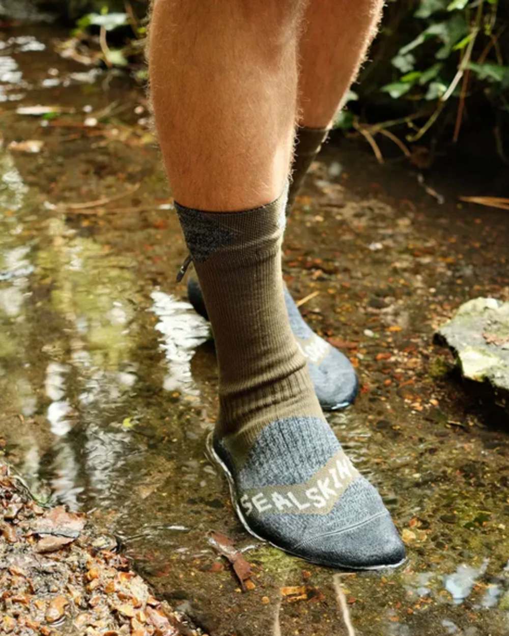 Olive Coloured Sealskinz Raynham Waterproof All Weather Mid Length Sock on outdoor background 