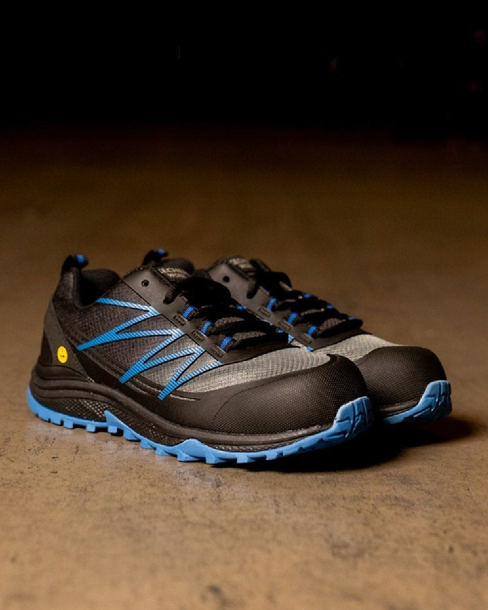 Black Blue Coloured Skechers Workwear Mens Puxal Safety Trainers on indoor background 