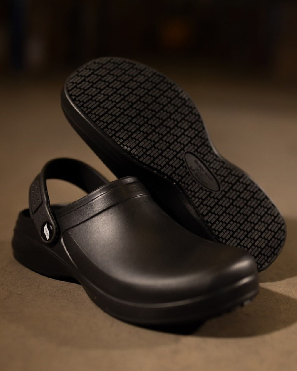 Black Coloured Skechers Workwear Womens Riverbound Pasay Clogs on indoor background 