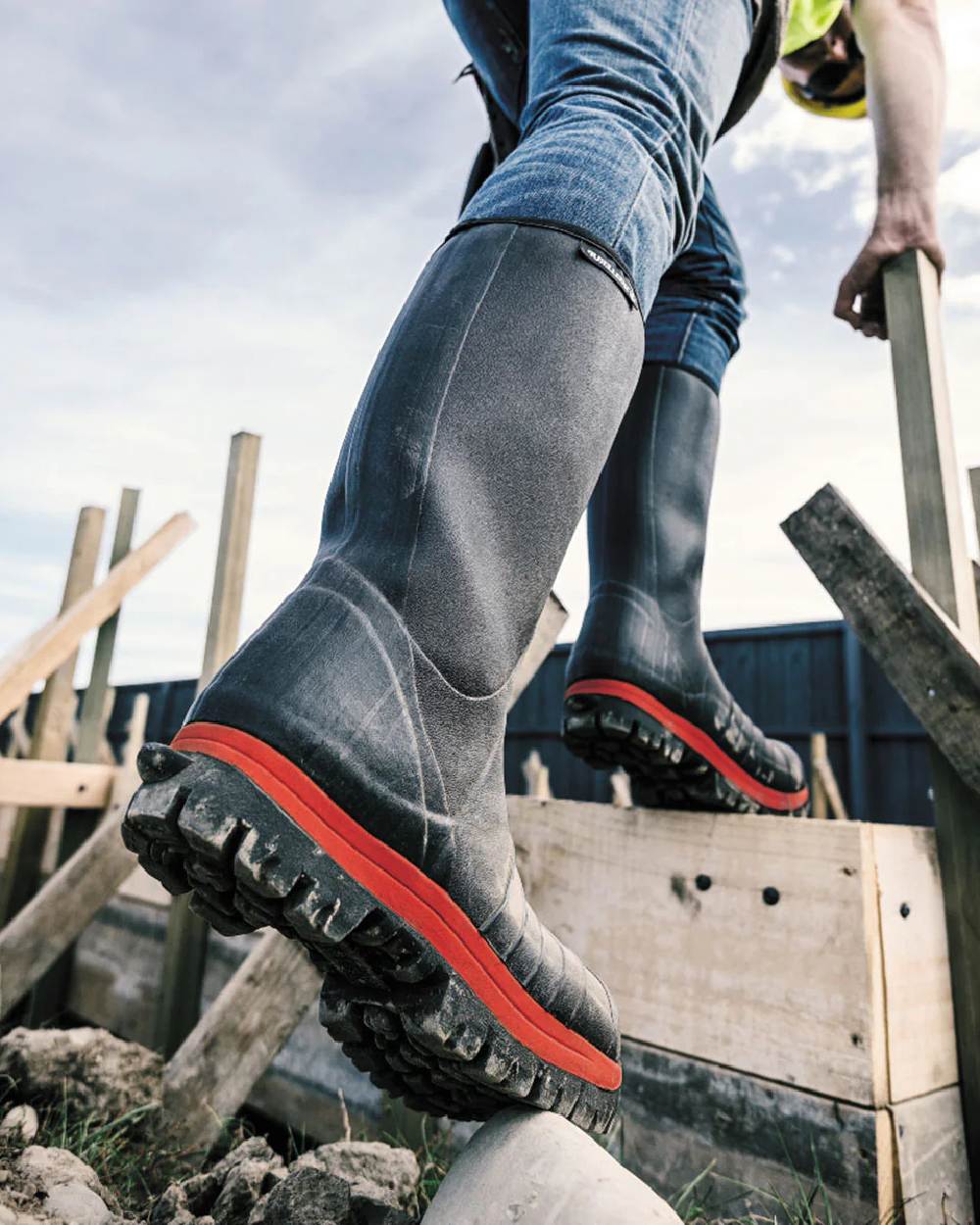 Black Red coloured Skellerup Quatro Super Safety S5 Insulated Black Boot on outdoor  background 