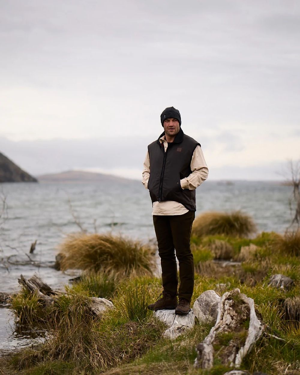 Brown Coloured Swanndri Mens Foxton Oilskin Vest with Wool Lining on sea background 