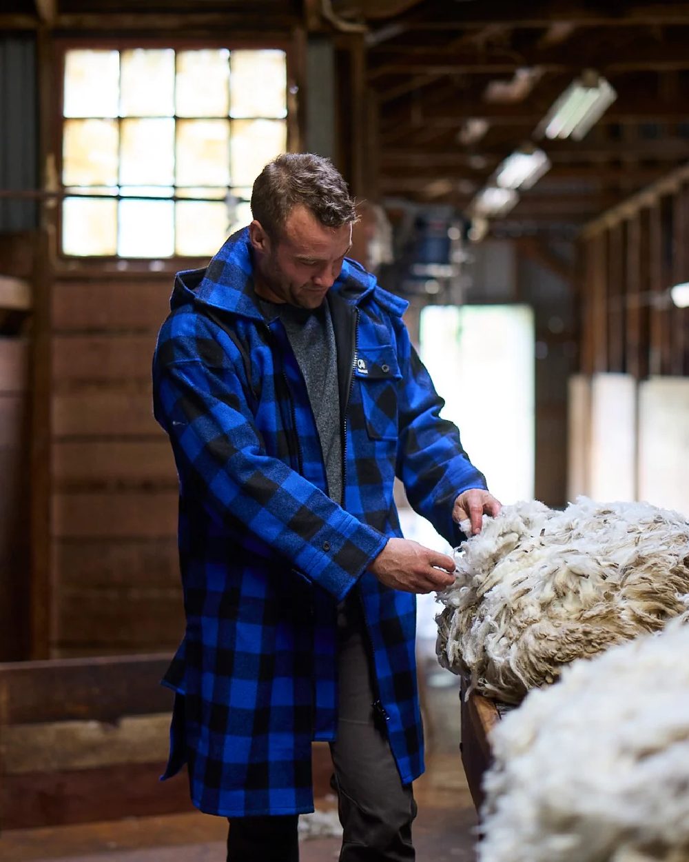 Blue Black Check Coloured Swanndri Mens Mosgiel Wool Bushshirt with Zip-up Front on factory background 
