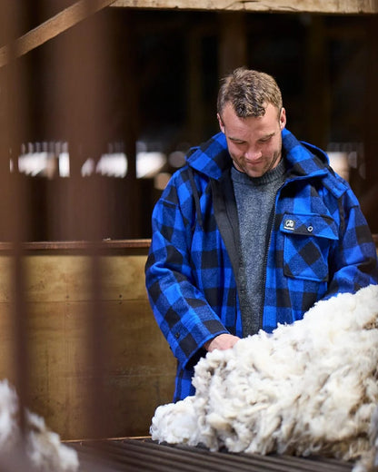 Blue Black Check Coloured Swanndri Mens Mosgiel Wool Bushshirt with Zip-up Front on factory background 