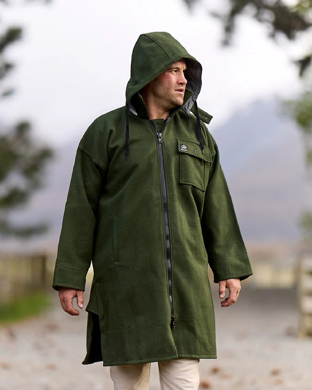Olive Coloured Swanndri Mens Mosgiel Wool Bushshirt with Zip-up Front on blurry background 