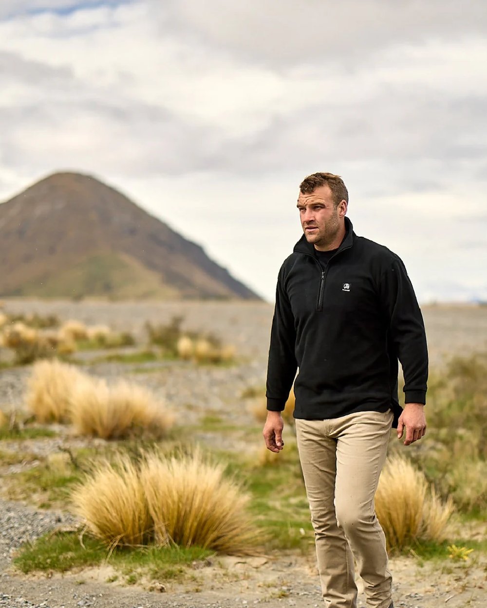 Black Coloured Swanndri Mens Motu Fleece Pullover on mountain background 