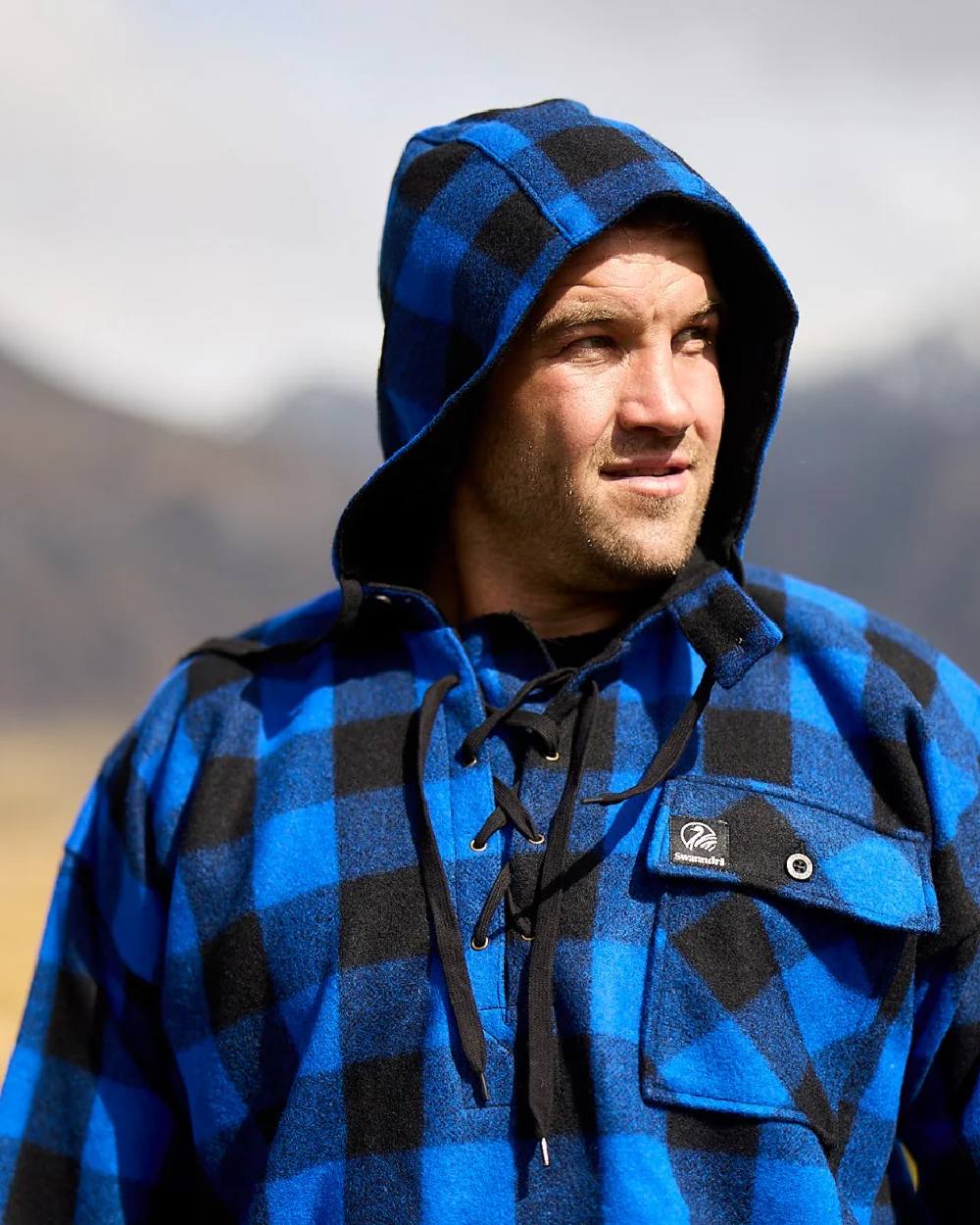 Blue Black Check Coloured Swanndri Mens Original Wool Bushshirt With Lace-Up Front on blurry background 