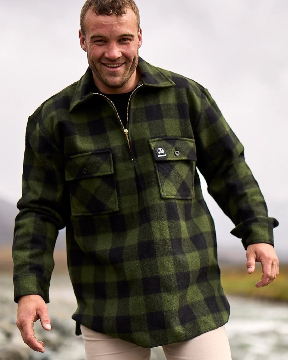 Olive Black Check Coloured Swanndri Mens Ranger Wool Zip Front Bushshirt on blurry background 