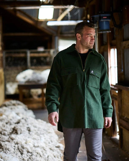 Olive Coloured Swanndri Mens Ranger Wool Zip Front Bushshirt on factory background 