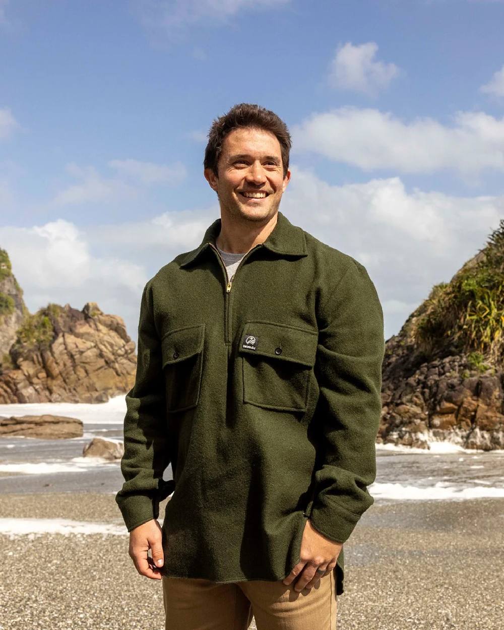 Olive Coloured Swanndri Mens Ranger Wool Zip Front Bushshirt on coastal background 