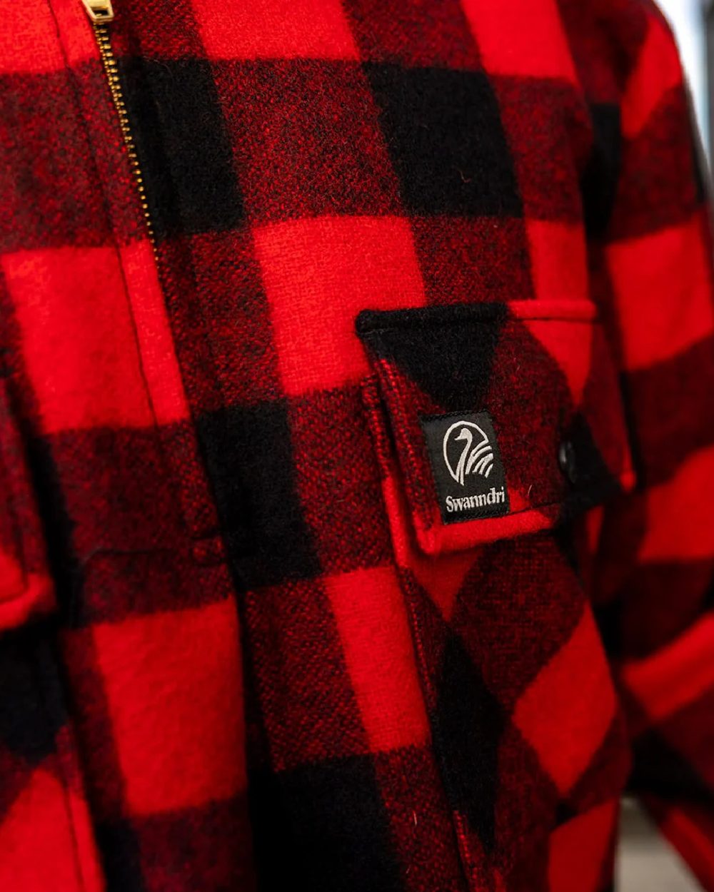 Red Black Check Coloured Swanndri Mens Ranger Wool Zip Front Bushshirt on blurry background 