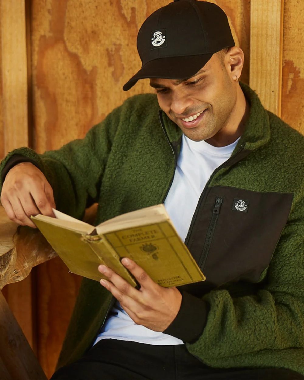 Black Coloured Swanndri Swanni Baseball Cap on cafe background 