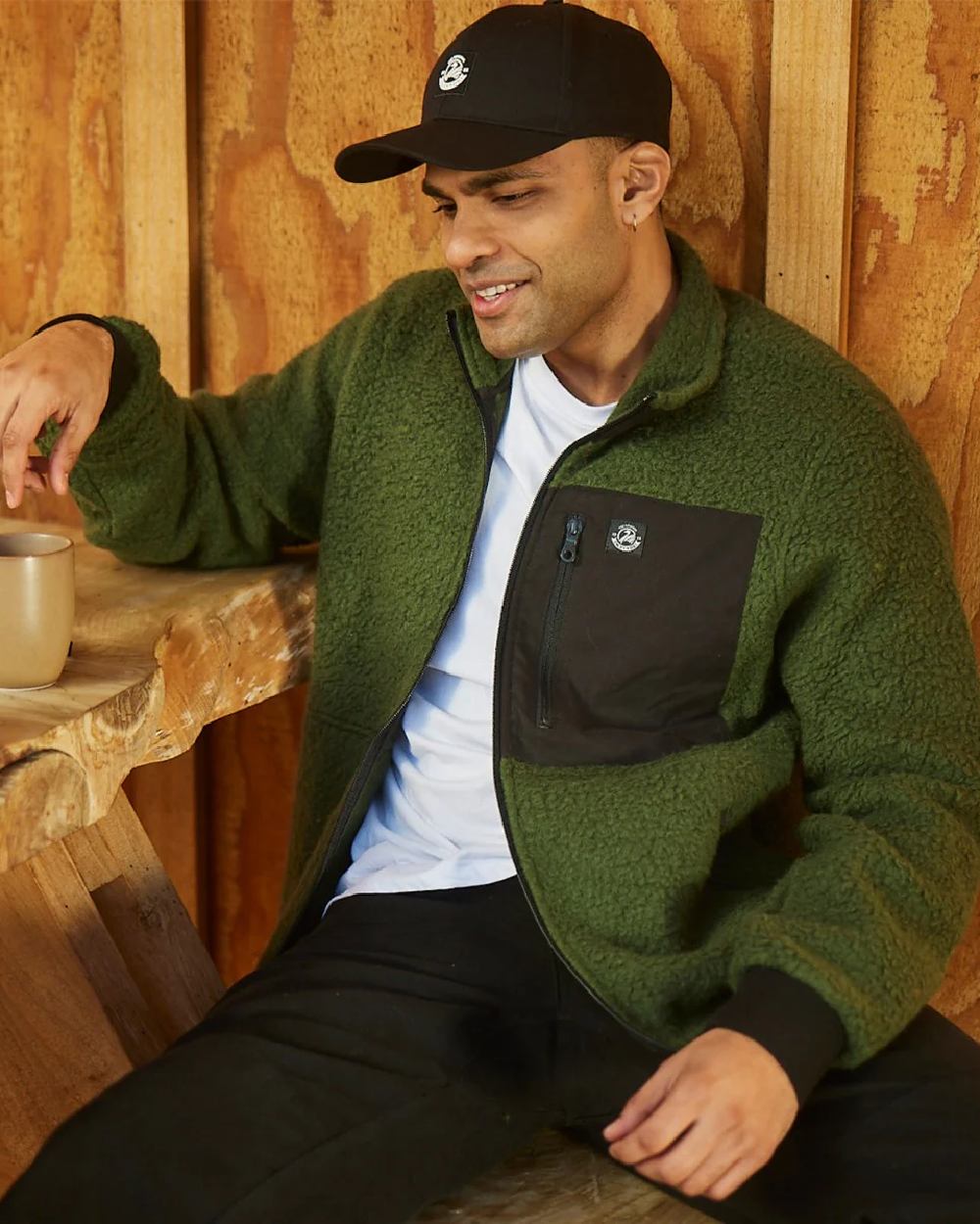 Black Coloured Swanndri Swanni Baseball Cap on cafe  background 