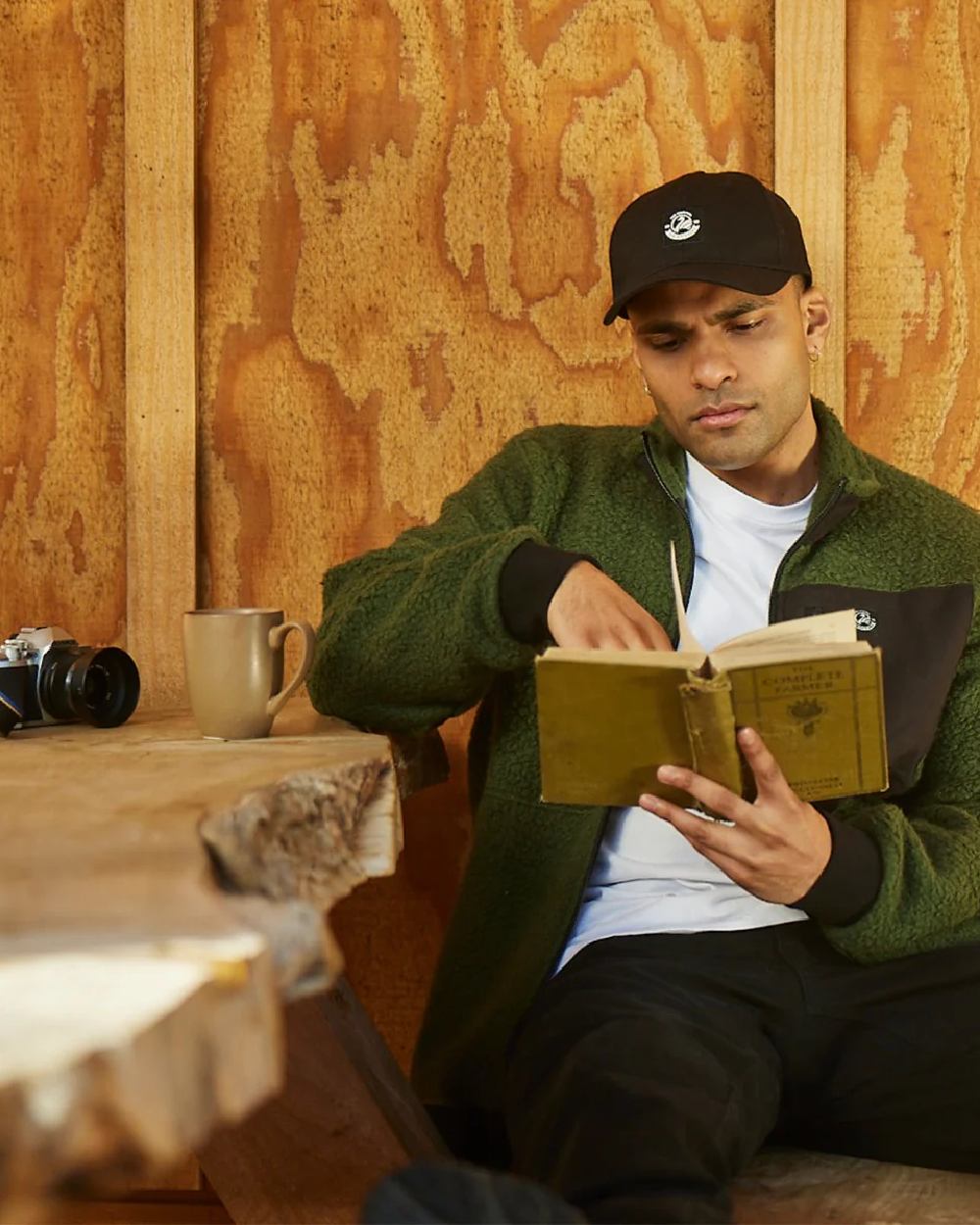 Black Coloured Swanndri Swanni Baseball Cap on cafe background 