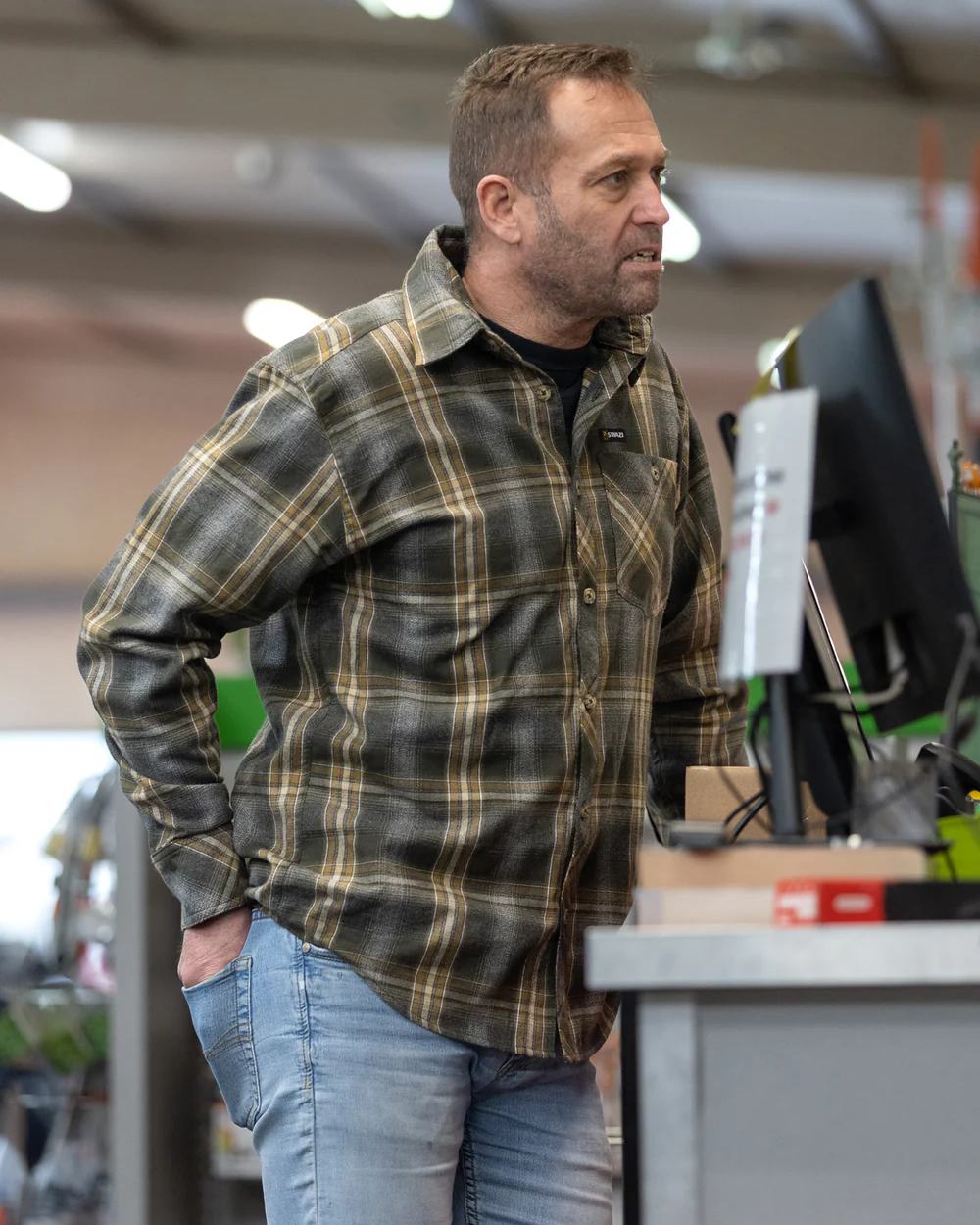 Olive coloured Swazi Grafter Shirt on blurry background 
