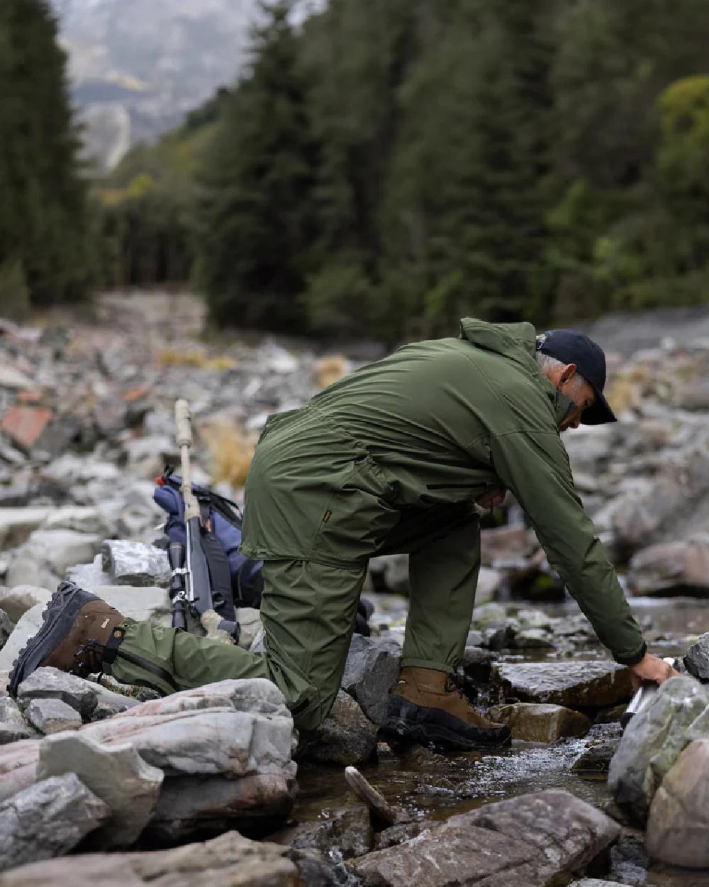 Olive coloured Swazi Mens Rifleman Ultralite Overpants on rock background 
