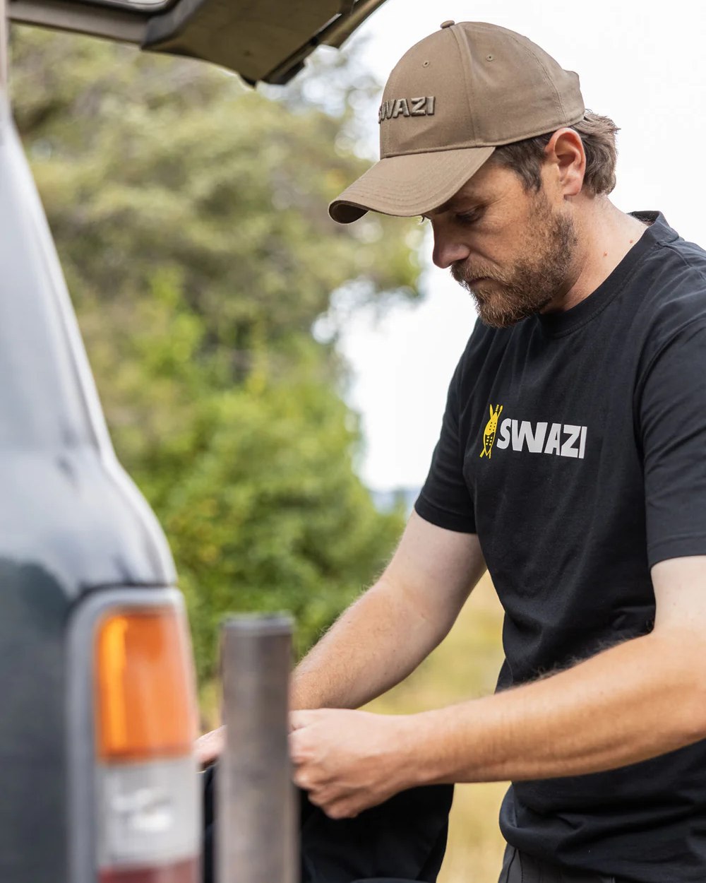 Black Coloured Swazi Tee on blurry background 