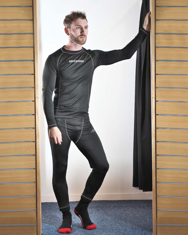 Black coloured TuffStuff Basewear Bottoms on fitting room background