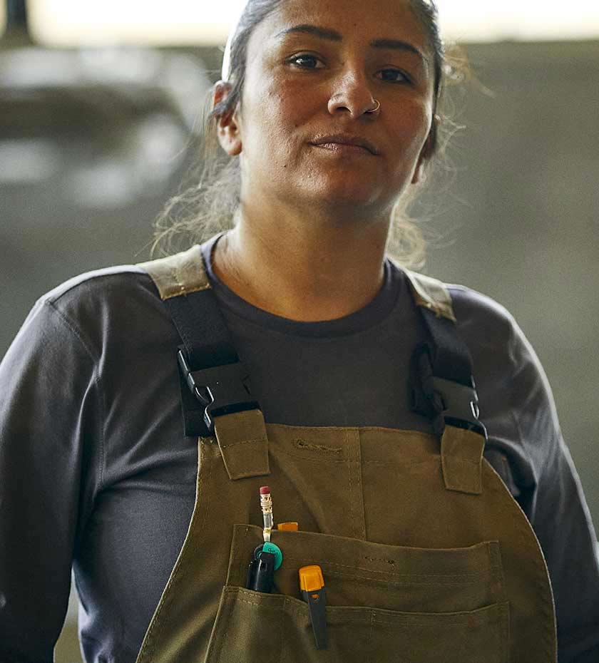 Woman wearing a brown dungaree engineers bib and brace overall