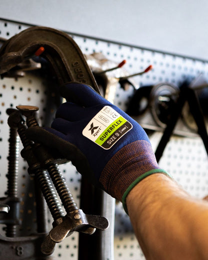 Navy Black coloured Xpert Core Superflex Dexterous Nitrile Palm Gloves on workstation background 
