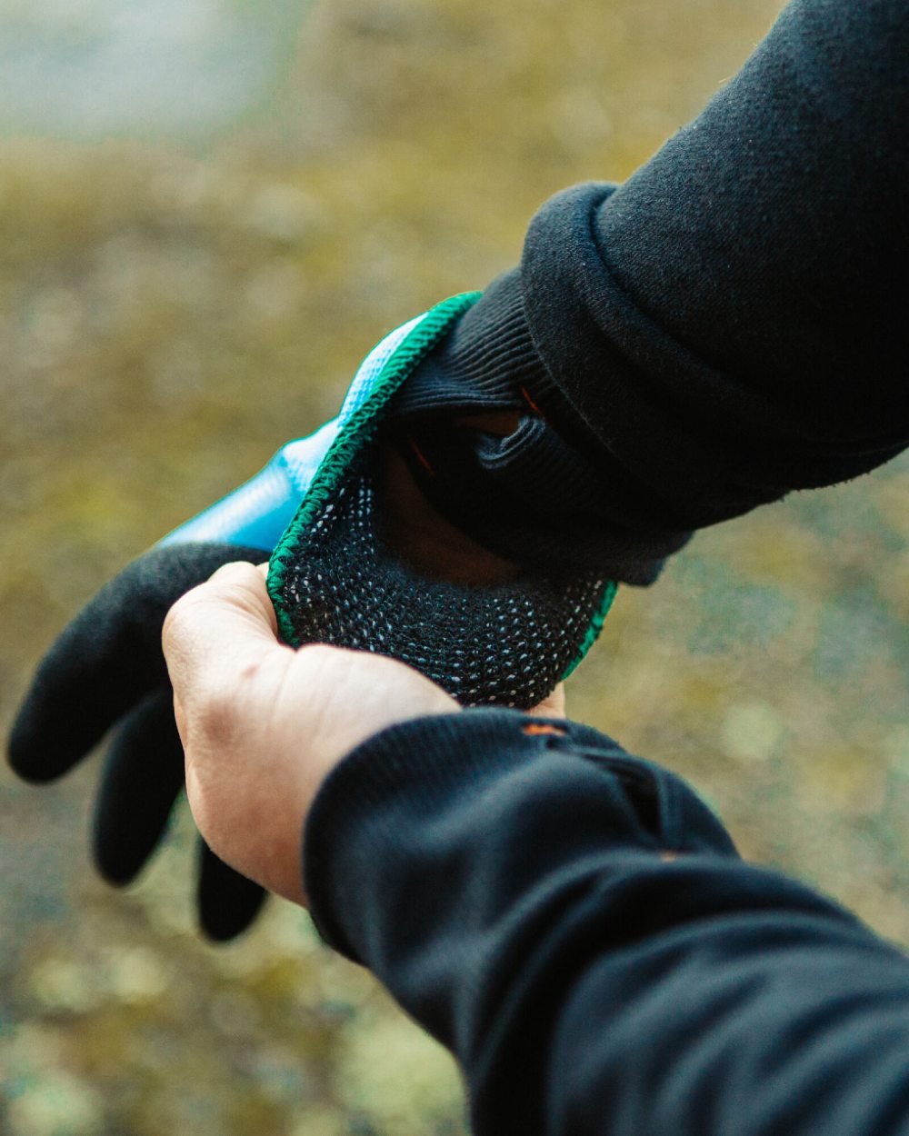 Blue Black coloured Xpert Core Thermdry Waterproof Thermal Fully Coated Gloves on outdoor background 