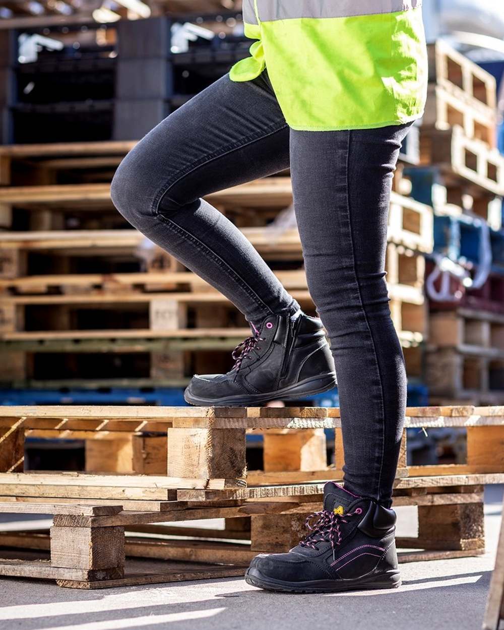 Black Coloured Amblers Safety Womens AS601 Lydia Side Zip Safety Boots on a workspace background