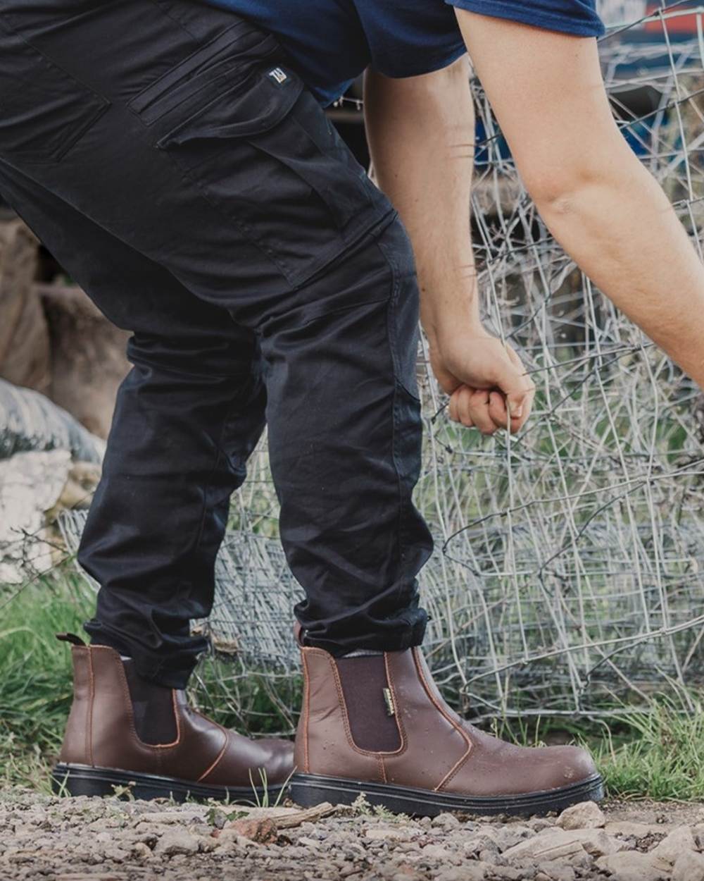 Brown Coloured Amblers Safety FS128 Hardwearing Pull On Safety Dealer Boots on street background