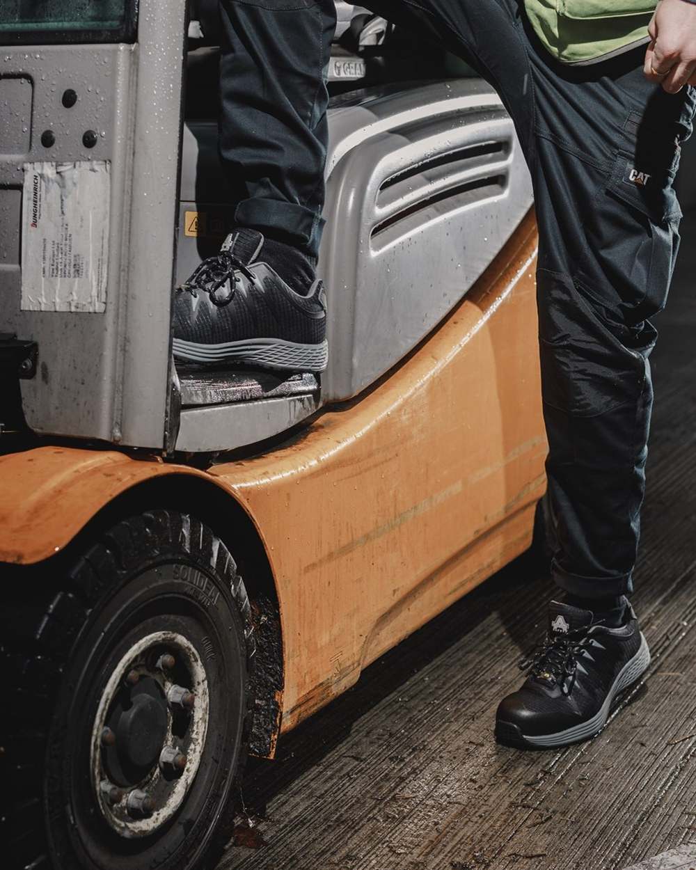 Black Coloured Amblers Safety Mens Womens AS717C Safety Trainer on a vehicle background
