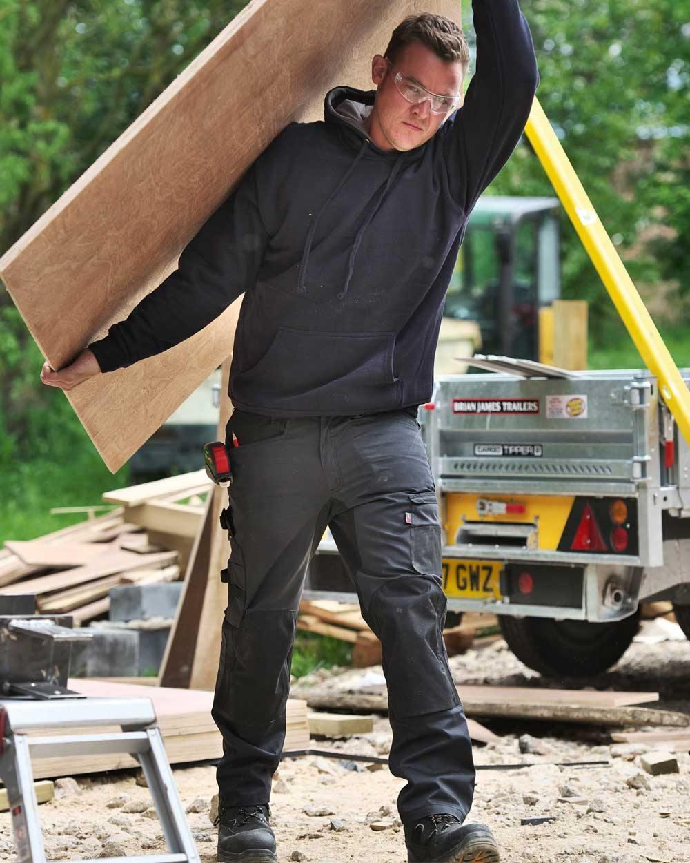 Grey Coloured TuffStuff X Motion Work Trousers On A Warehouse Background