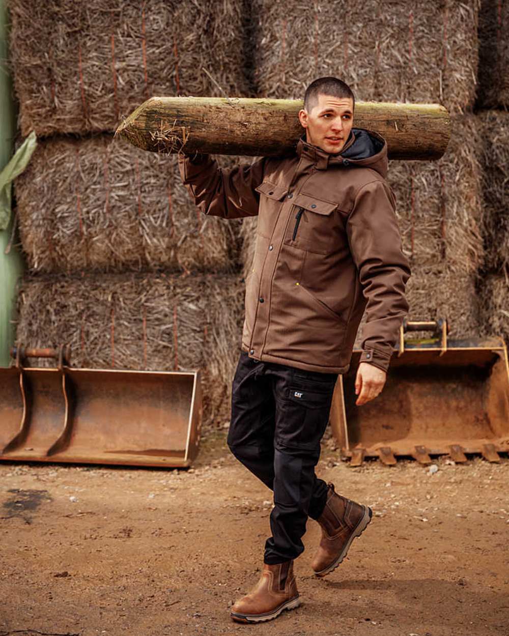 Dark Beige Coloured Caterpillar Pelton S1P Safety Boot On A Farm Background