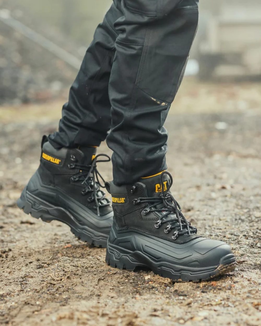 Black Coloured Caterpillar Typhoon SBH Safety Boot On A Street Background